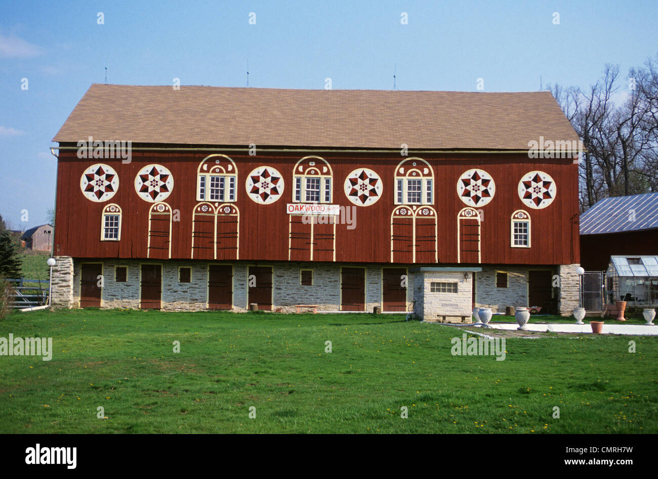 1990s Red Barn With Hex Signs Between Doors And Windows Stock