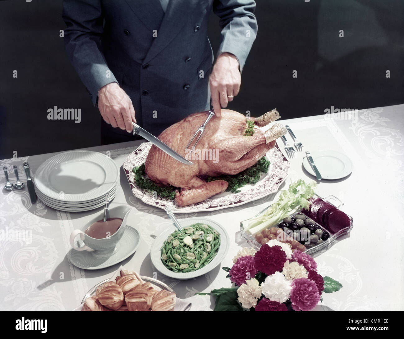1950s MALE HANDS ABOUT TO CARVE THANKSGIVING TURKEY TABLE SETTING