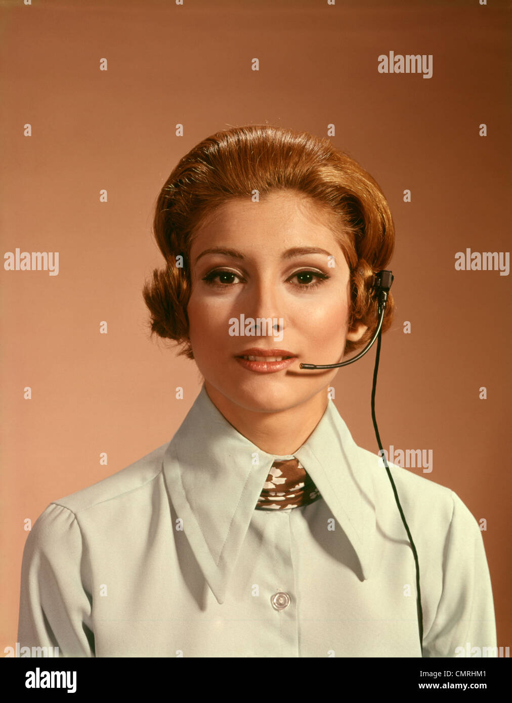 1960s 1970s PORTRAIT WOMAN TELEPHONE OPERATOR RECEPTIONIST OFFICE WORKER WEARING HEADSET Stock Photo