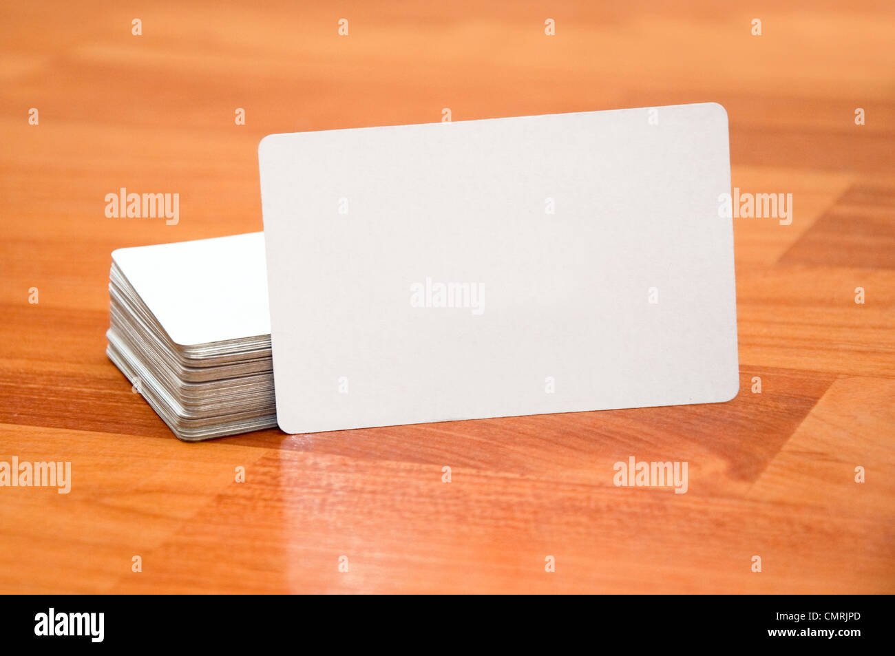Stack of business cards with rounded corners over a white background ...