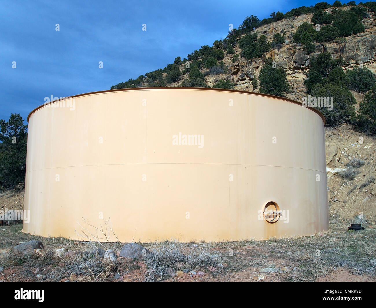 A large culinary water tank on a small hill in a rural community. Stock Photo