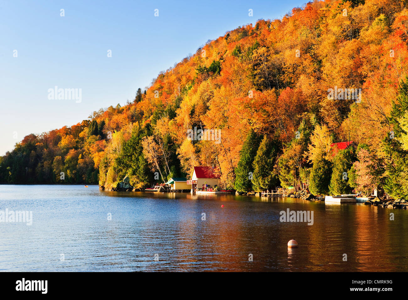 Cottage and fall colours at Memphremagog Lake at sunrise, Eastern