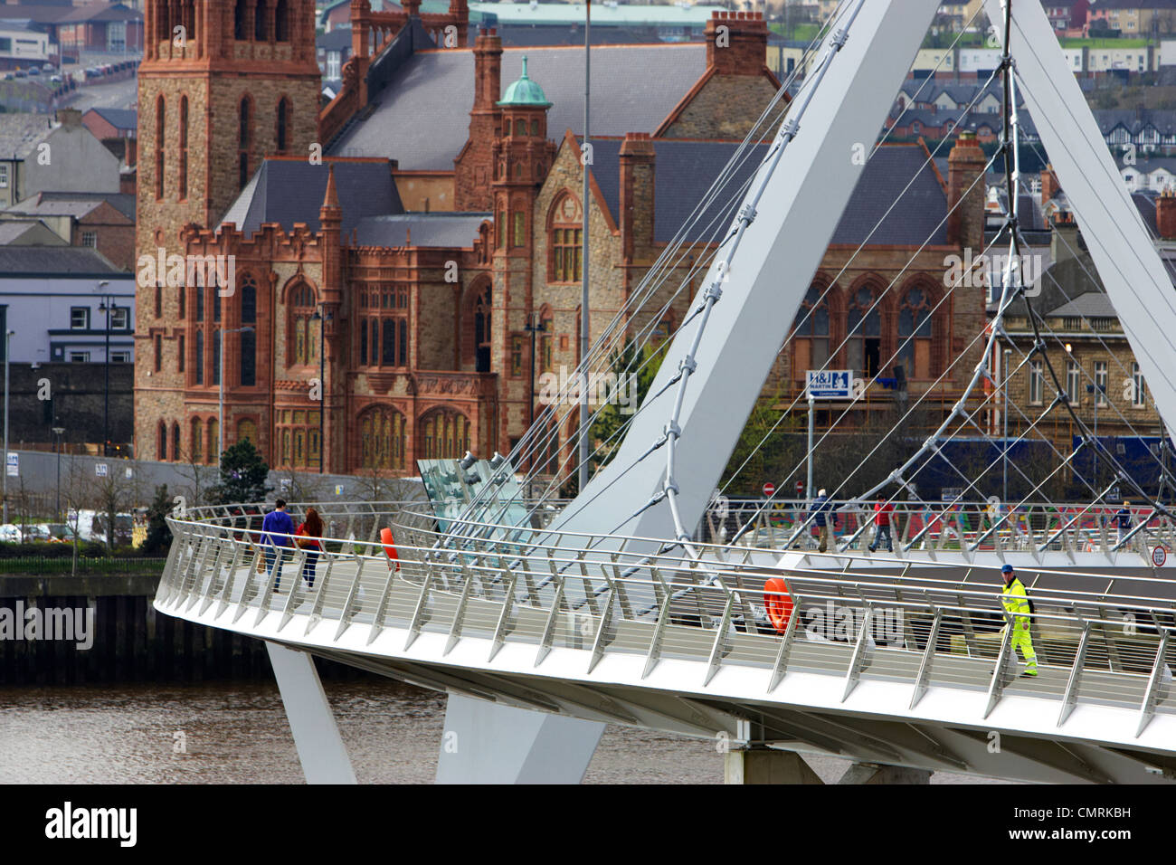 people crossing the new peace bridge in Derry city county londonderry northern ireland uk. Stock Photo