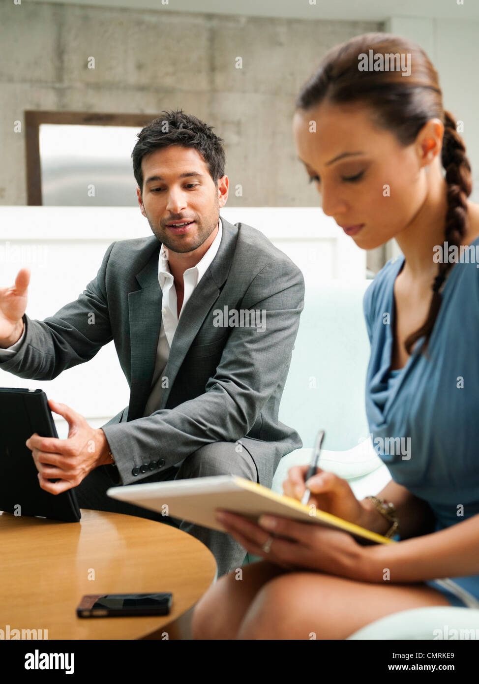Business people working together in lobby Stock Photo - Alamy