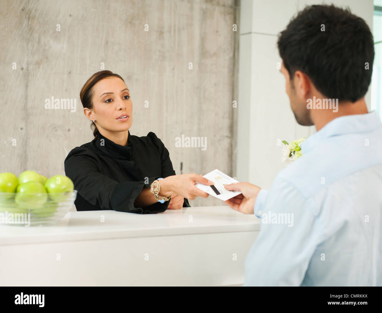 Businessman checking in to hotel Stock Photo