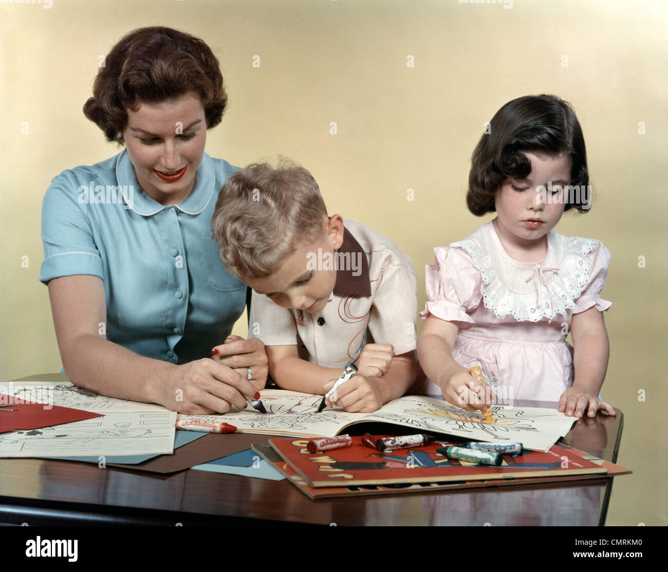 MOTHER SON AND DAUGHTER COLORING IN COLORING BOOKS STUDIO Stock Photo