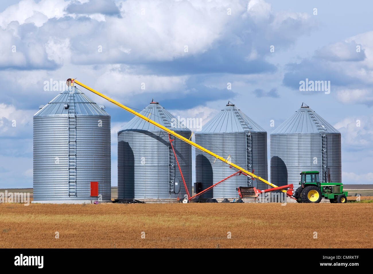 Grain auger and tractor ready to fill silo, Assiniboia, Saskatchewan