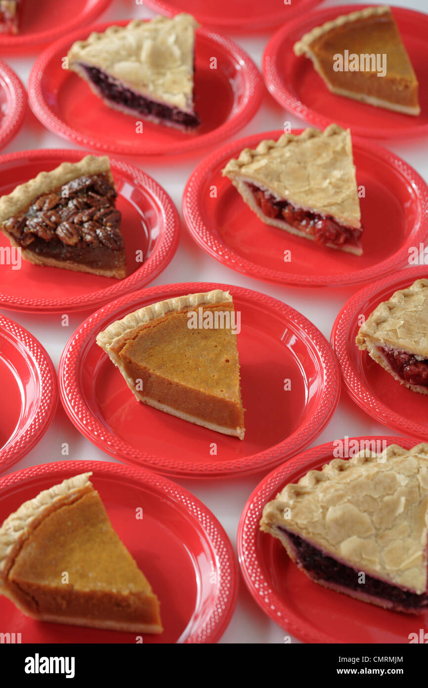 Variety of slices of pie on plates Stock Photo