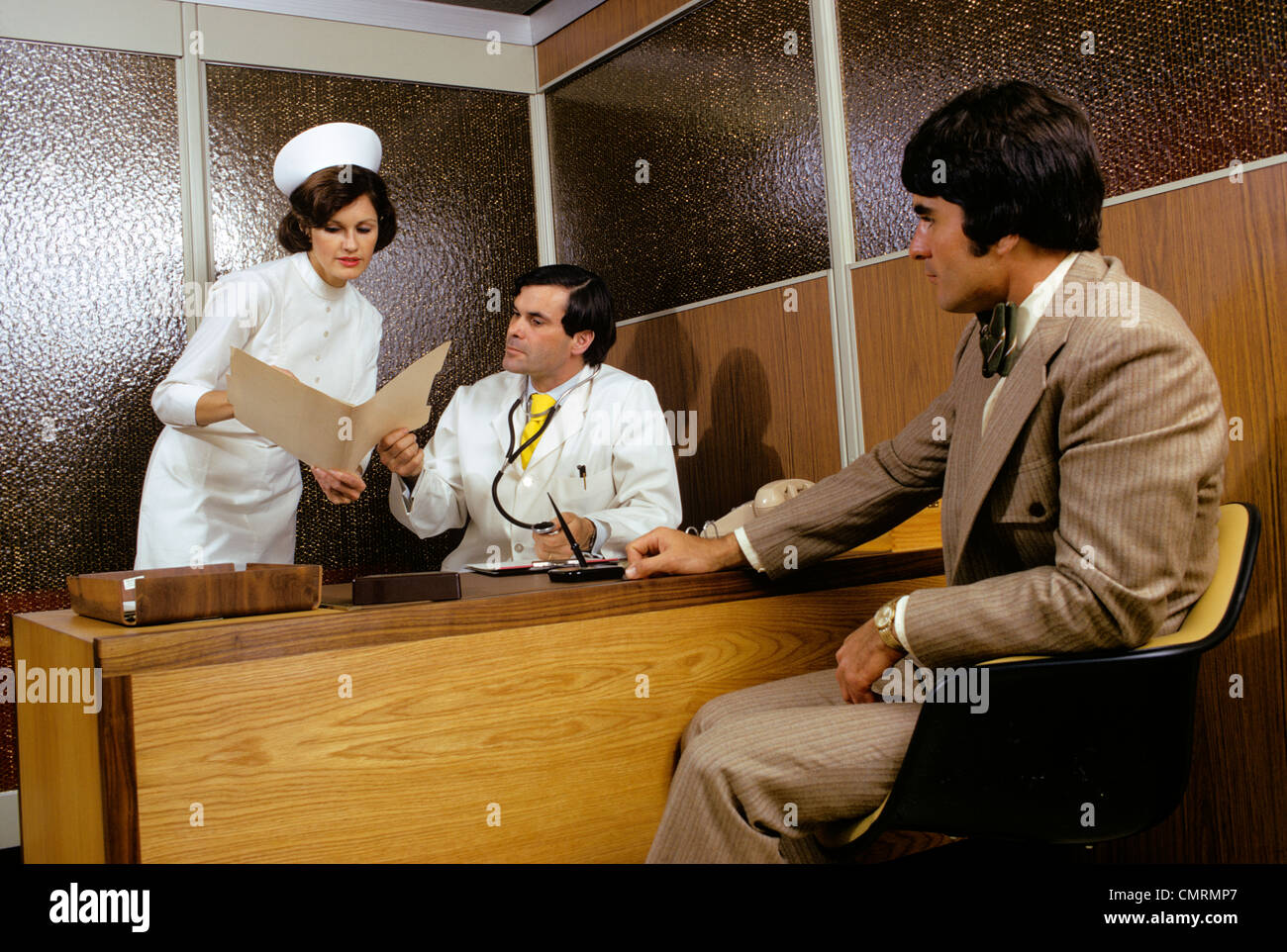 1970 1970s RETRO MAN PATIENT MEETING IN DOCTORS OFFICE NURSE SHOWING ...