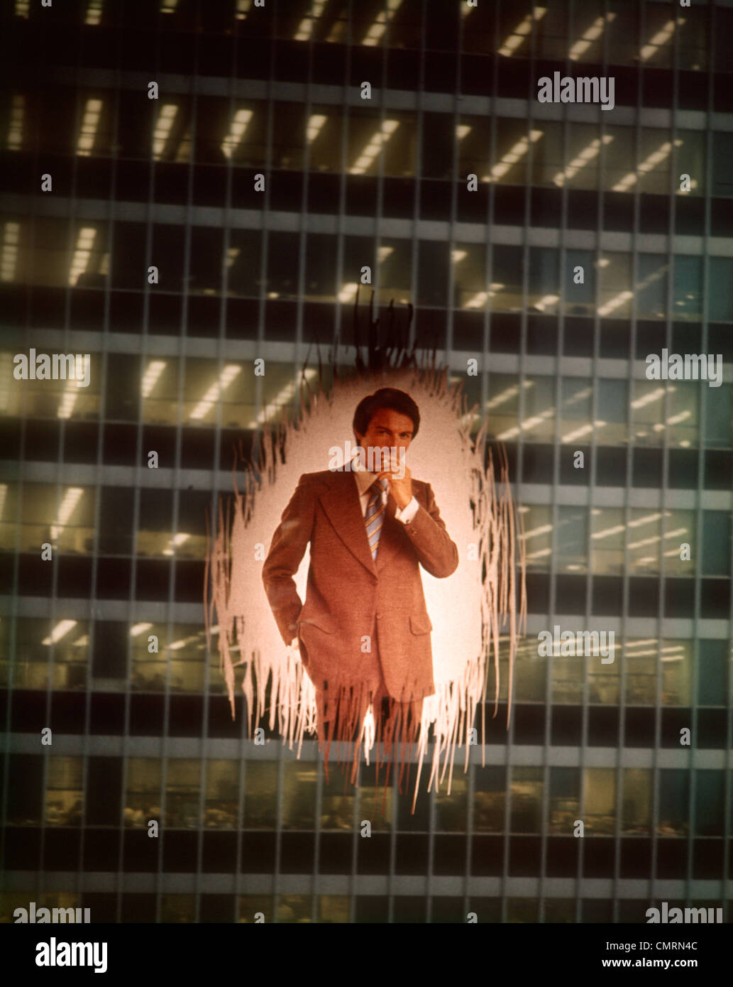1970 1970s MAN BUSINESSMAN EXECUTIVE SMOKING CIGARETTE IMPOSED EXTERIOR SHOT OFFICE BULDING WINDOW MYSTERY STORY Stock Photo