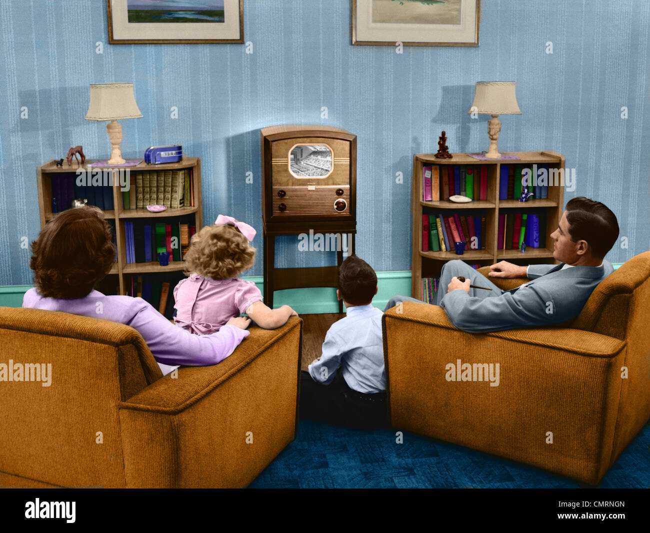 1940s 1950s FAMILY WATCHING TELEVISION IN LIVING ROOM Stock Photo
