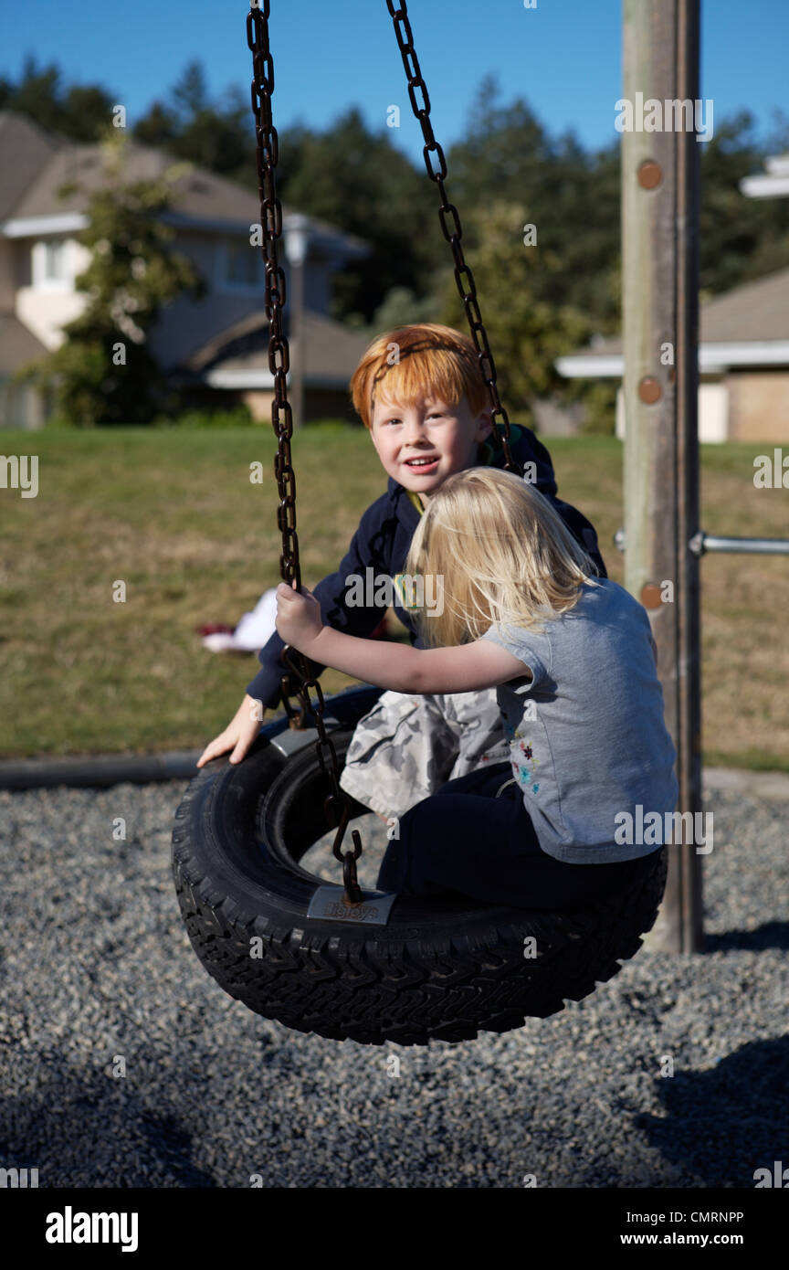 Kids swinging at a playground, Victoria, British Columbia Stock Photo
