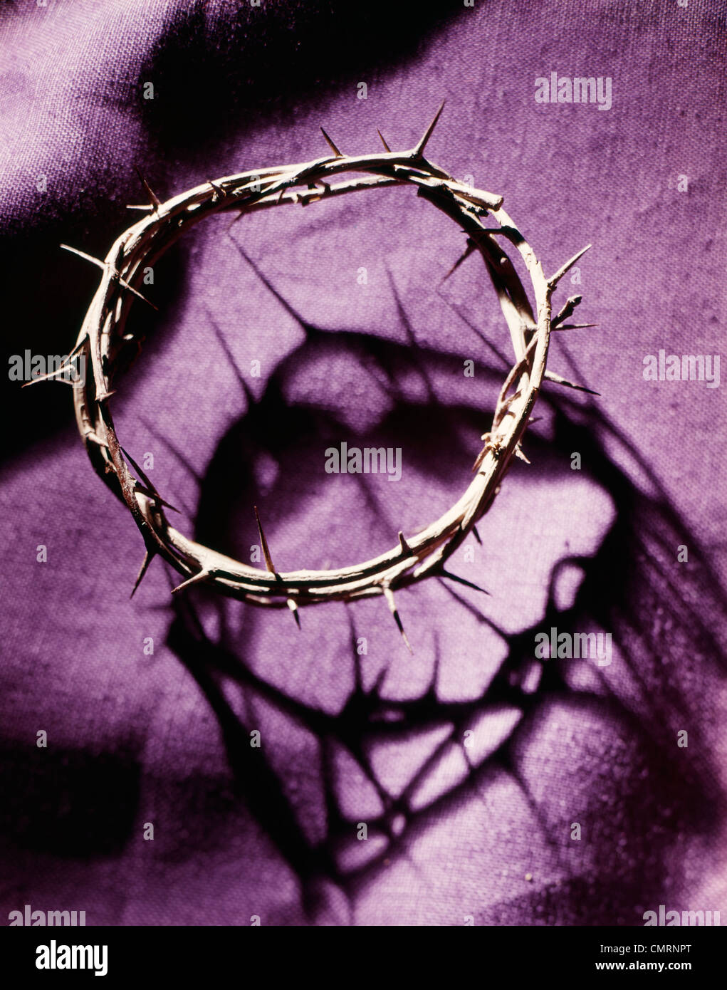 CROWN OF THORNS ON PURPLE CLOTH Stock Photo
