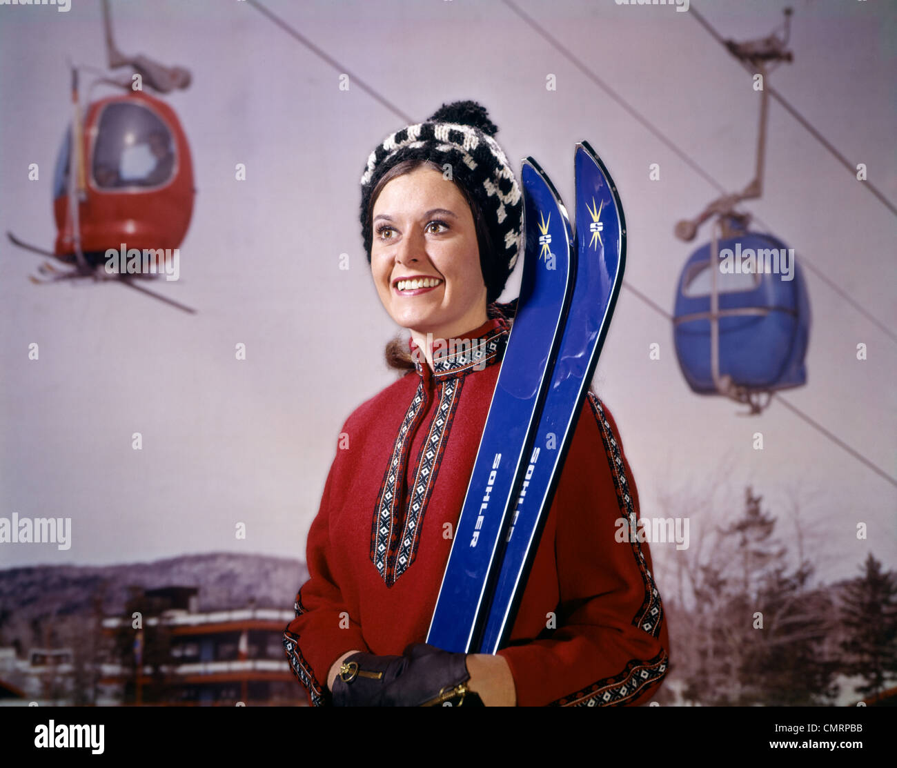 1960s 1970s SMILING WOMAN RED PONCHO BLUE SKIS SKI LIFT GONDOLA BACKGROUND RETRO Stock Photo