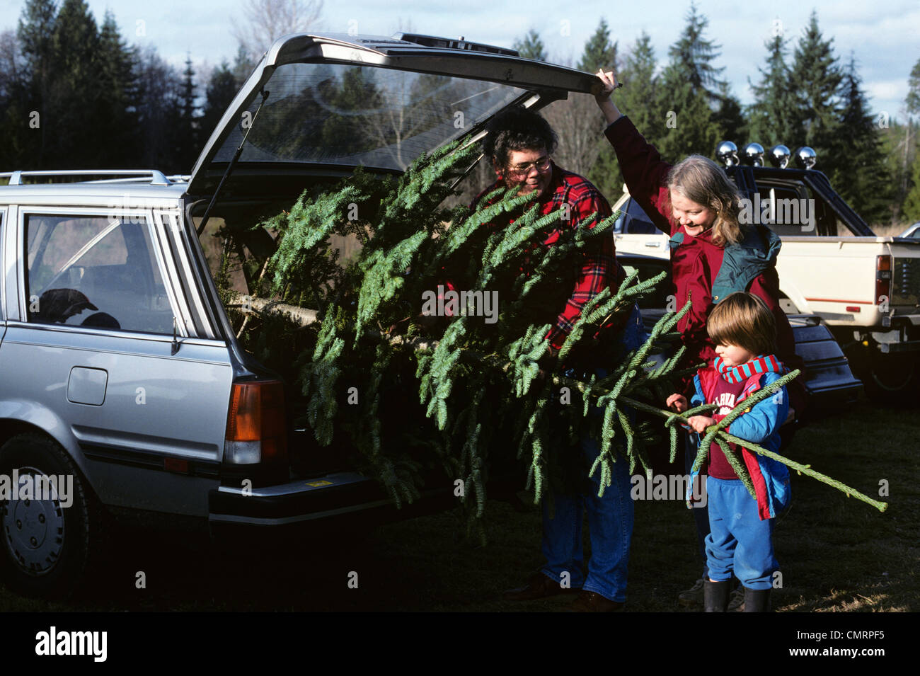 1980 1980s RETRO FAMILY CHRISTMAS TREE CAR Stock Photo