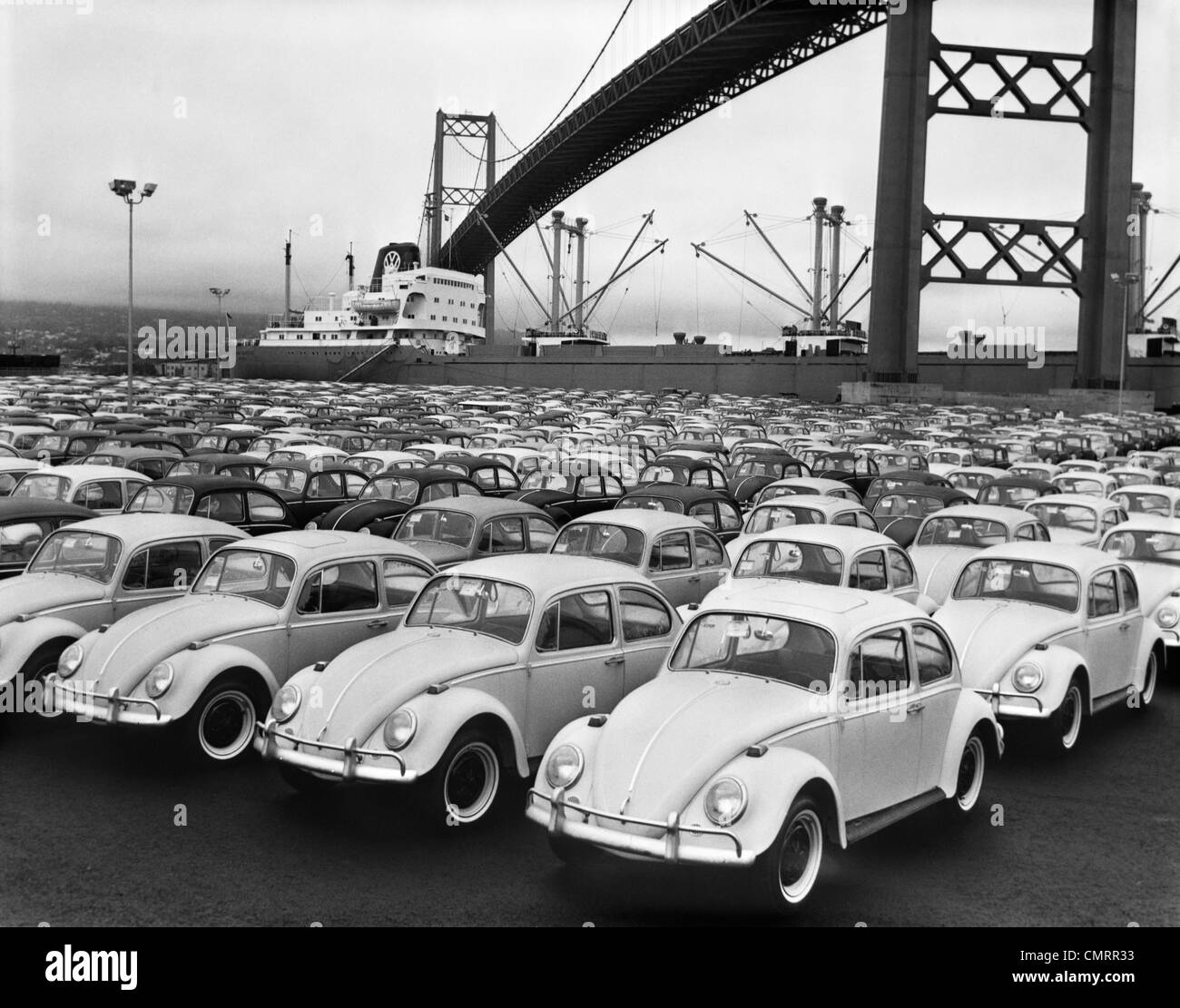 1960s LOADING DOCK WITH PARKED VOLKSWAGEN BEETLES Stock Photo