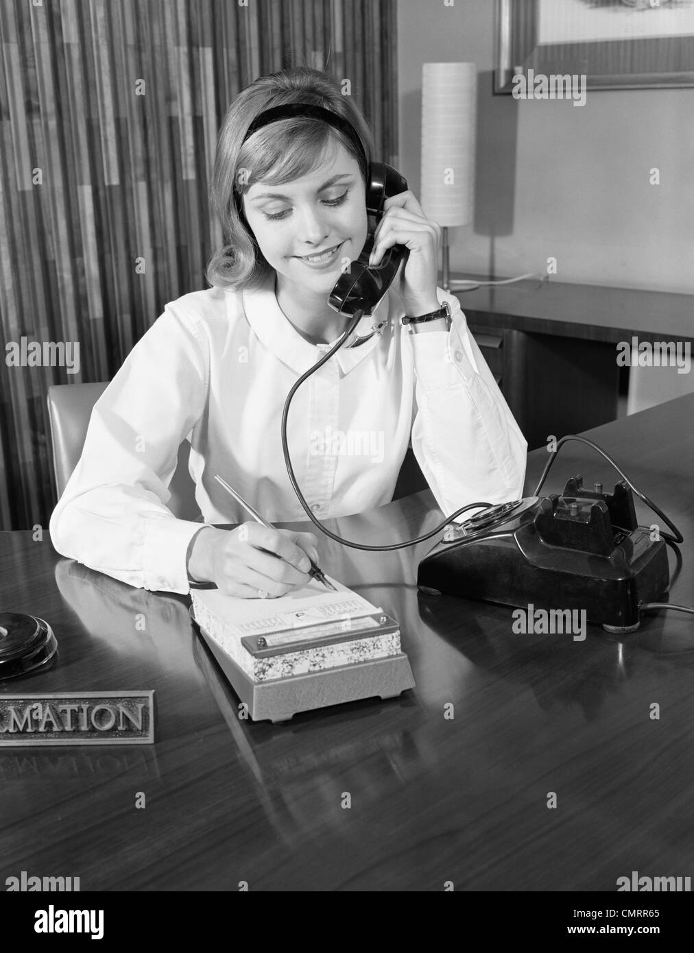 1960s SECRETARY RECEPTIONIST TALKING ON TELEPHONE WRITING INTO DESK  CALENDAR Stock Photo - Alamy
