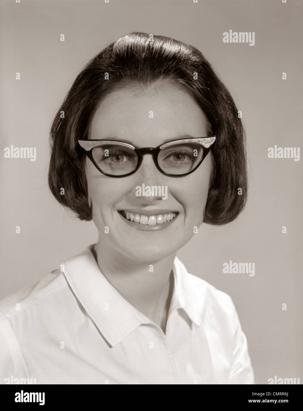 1960s SMILING PORTRAIT WOMAN WEARING HORN-RIMMED GLASSES LOOKING AT CAMERA Stock Photo