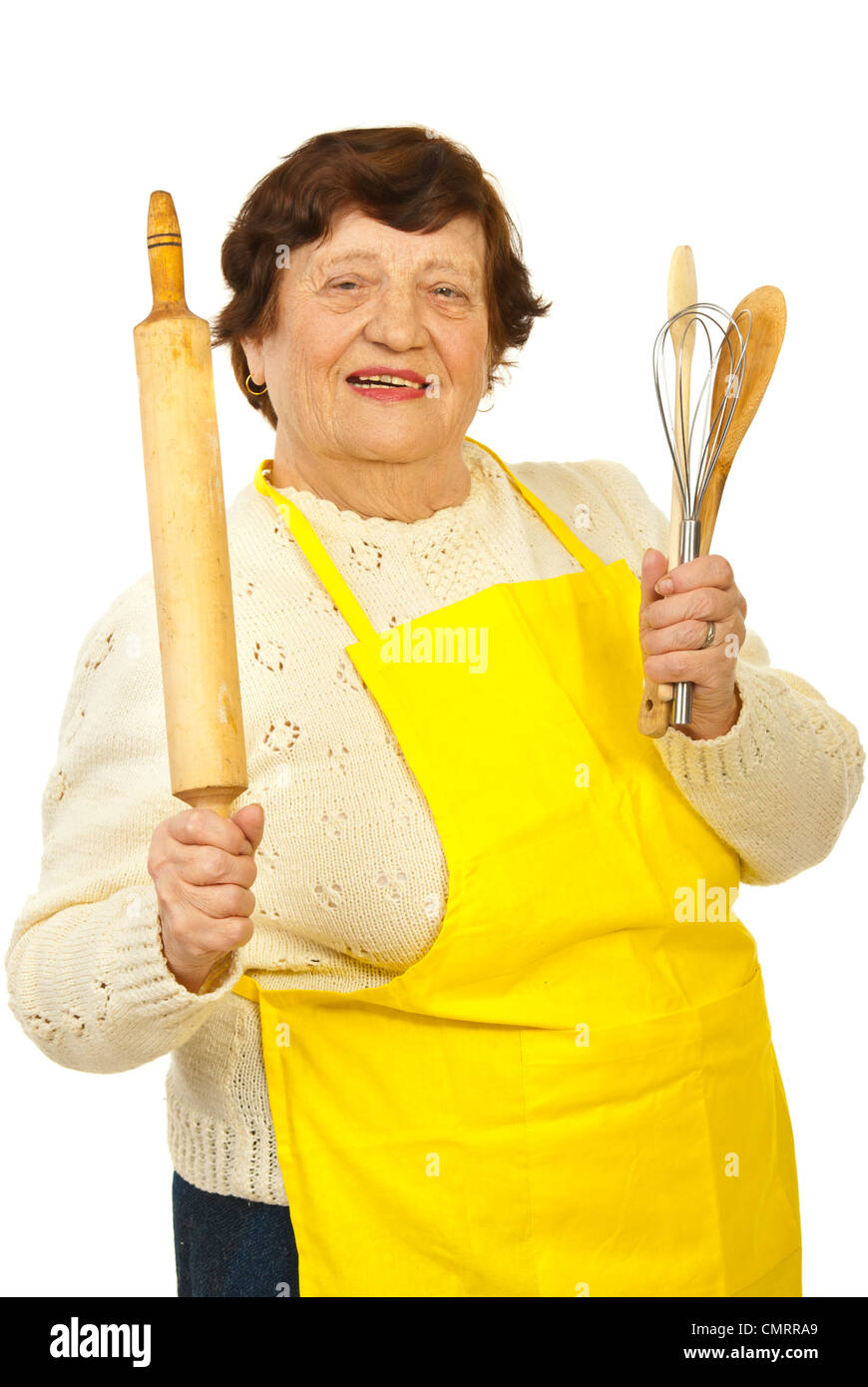Happy elderly woman holding kitchen utensils isolated on white
