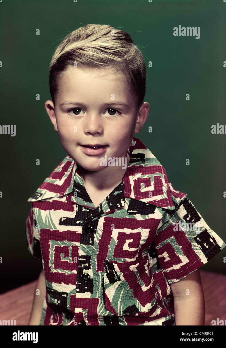 1950s PORTRAIT SMILING BOY WEARING GRAPHIC PRINTED SHIRT LOOKING AT CAMERA Stock Photo