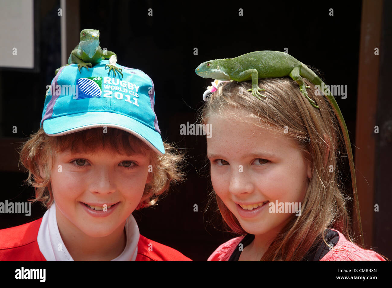 Children with Fiji Banded Iguanas (Brachylophus fasciatus), Kula Eco Park, Coral Coast, Viti Levu, Fiji, South Pacific Stock Photo