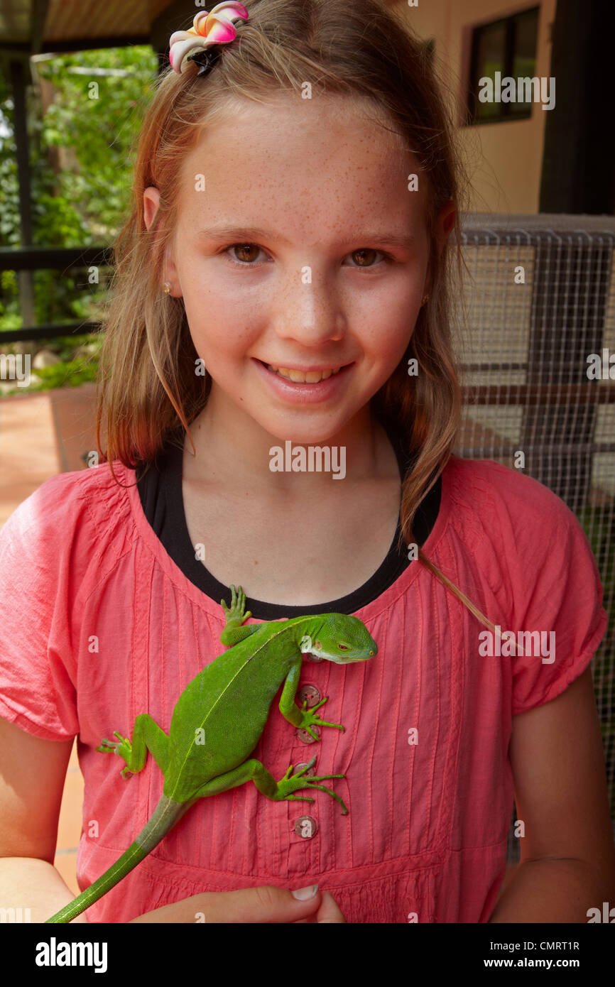 Girl and female Fiji Banded Iguana (Brachylophus fasciatus), Kula Eco Park, Coral Coast, Viti Levu, Fiji, South Pacific Stock Photo