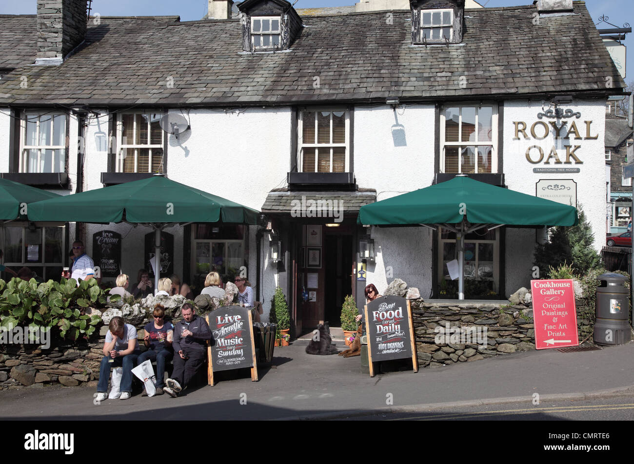 People drinking outside the Royal Oak pub in Ambleside, Cumbria, NW England, UK Stock Photo