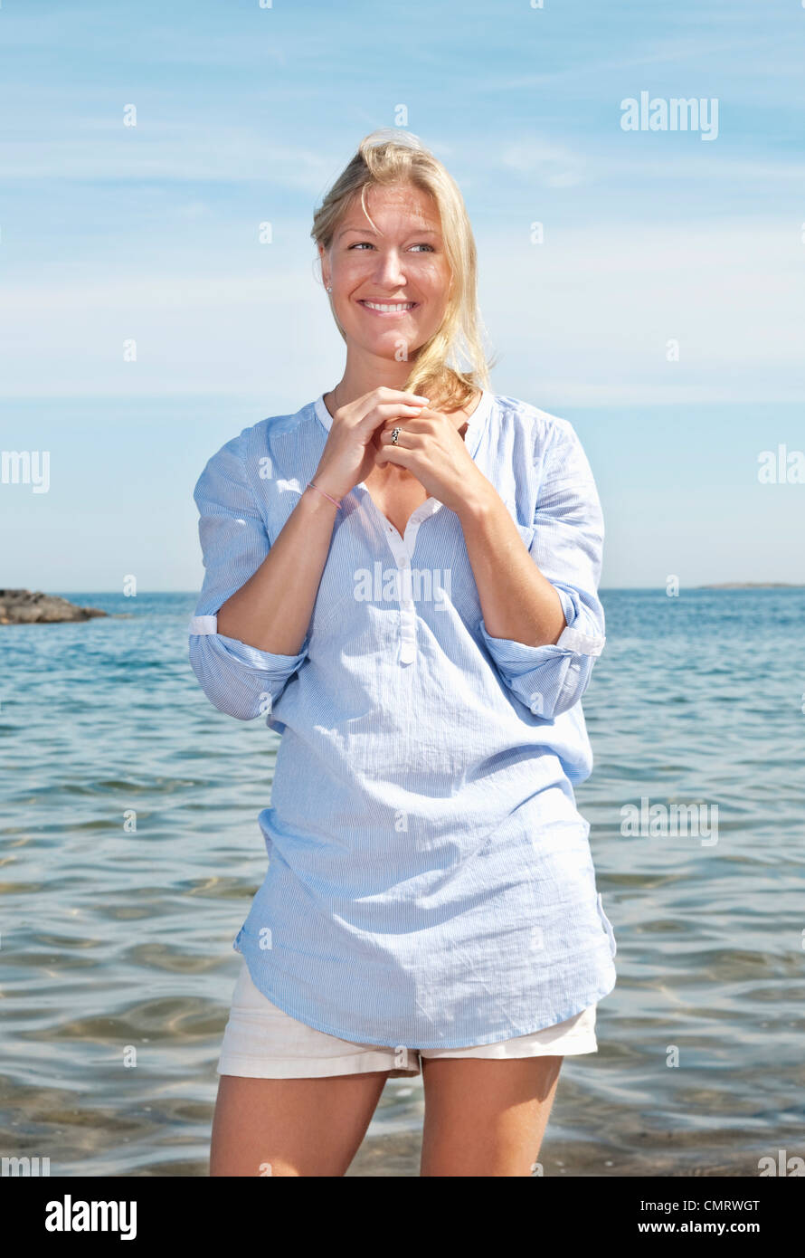 Woman standing by the water Stock Photo