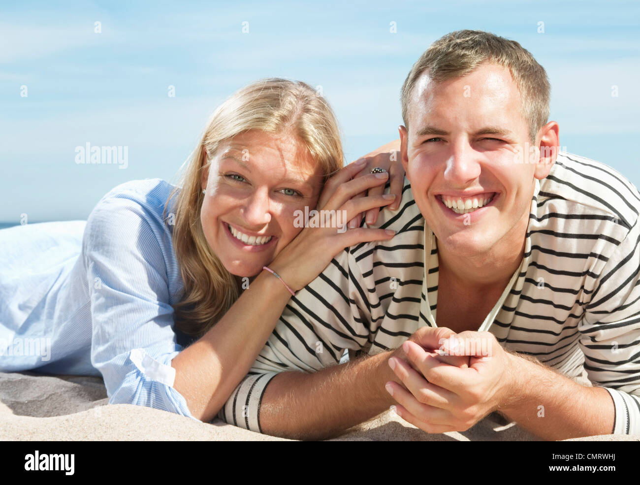 Two people lying on the beach Stock Photo