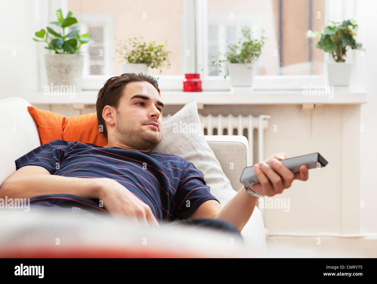 Man with remote control Stock Photo - Alamy