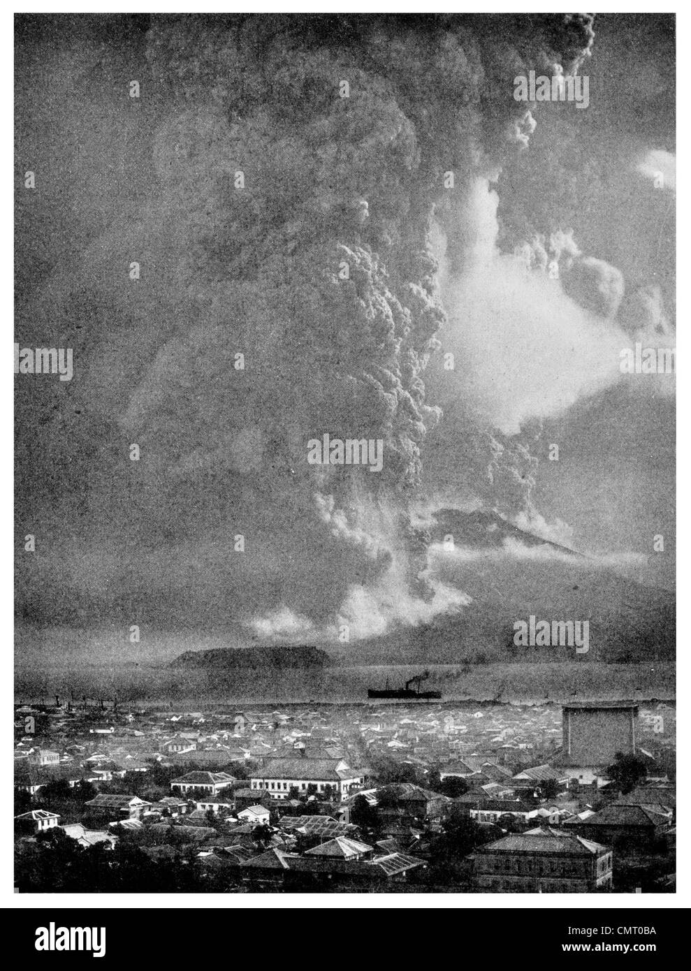 1914 Sakurajima Volcano in Eruption with City Kagoshima in foreground Stock Photo