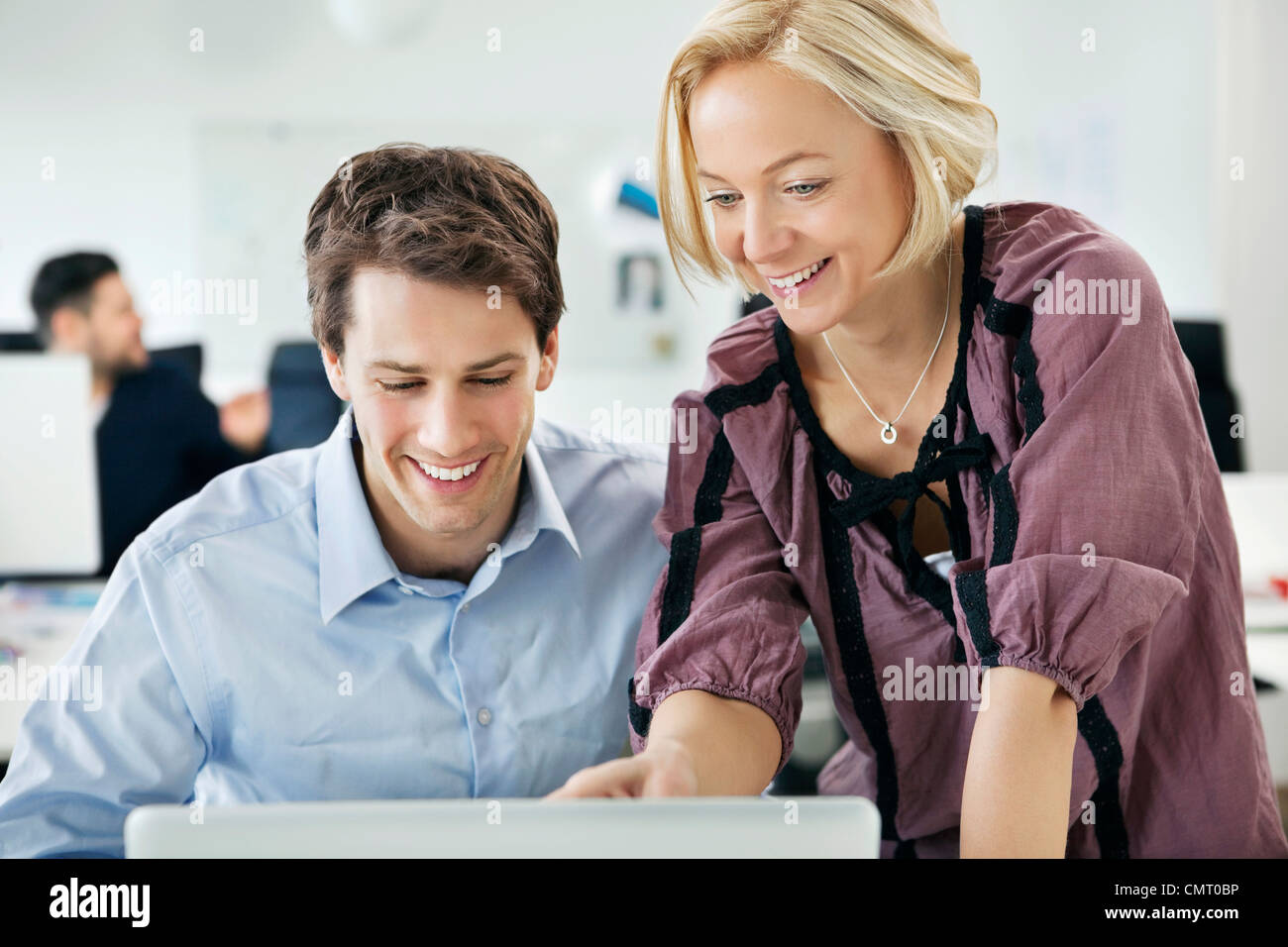 Two people helping each other at the office Stock Photo Alamy