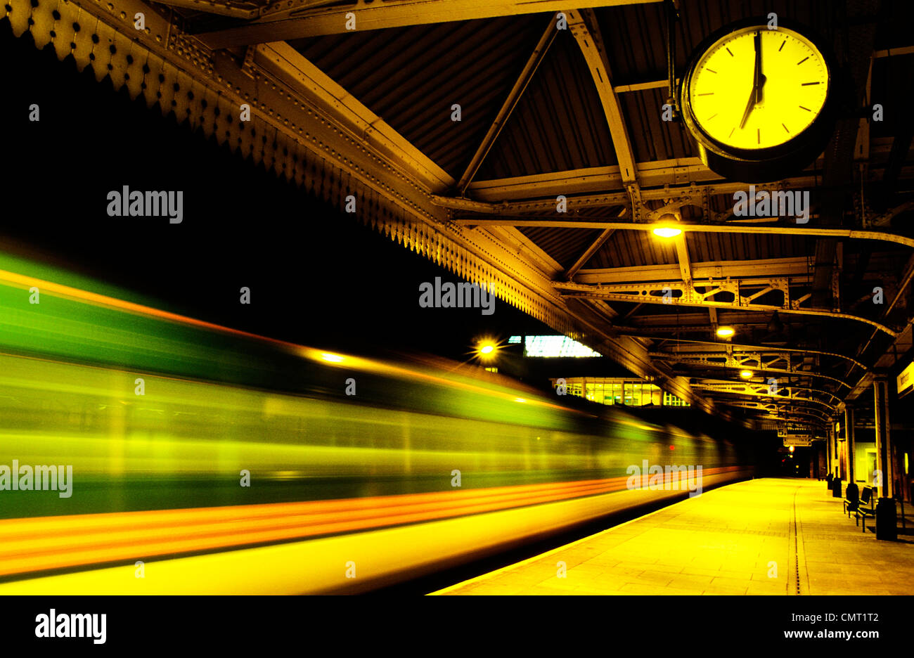 Station Clock showing Seven o'clock,time of departure for speeding train from an empty station platform Nottingham station England, UK,GB, Europe Stock Photo