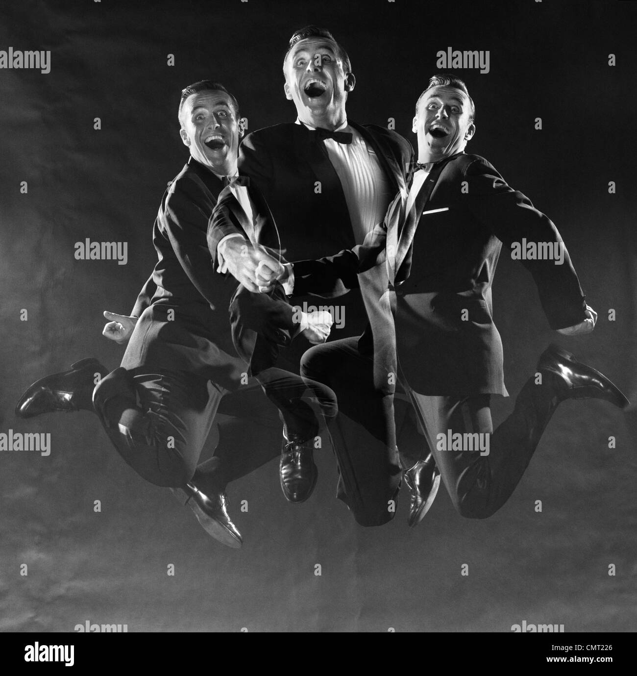 1950s 1960s GRAPHIC EFFECT TRIPLE EXPOSURE MAN IN DINNER JACKET JUMPING UP AND DOWN Stock Photo