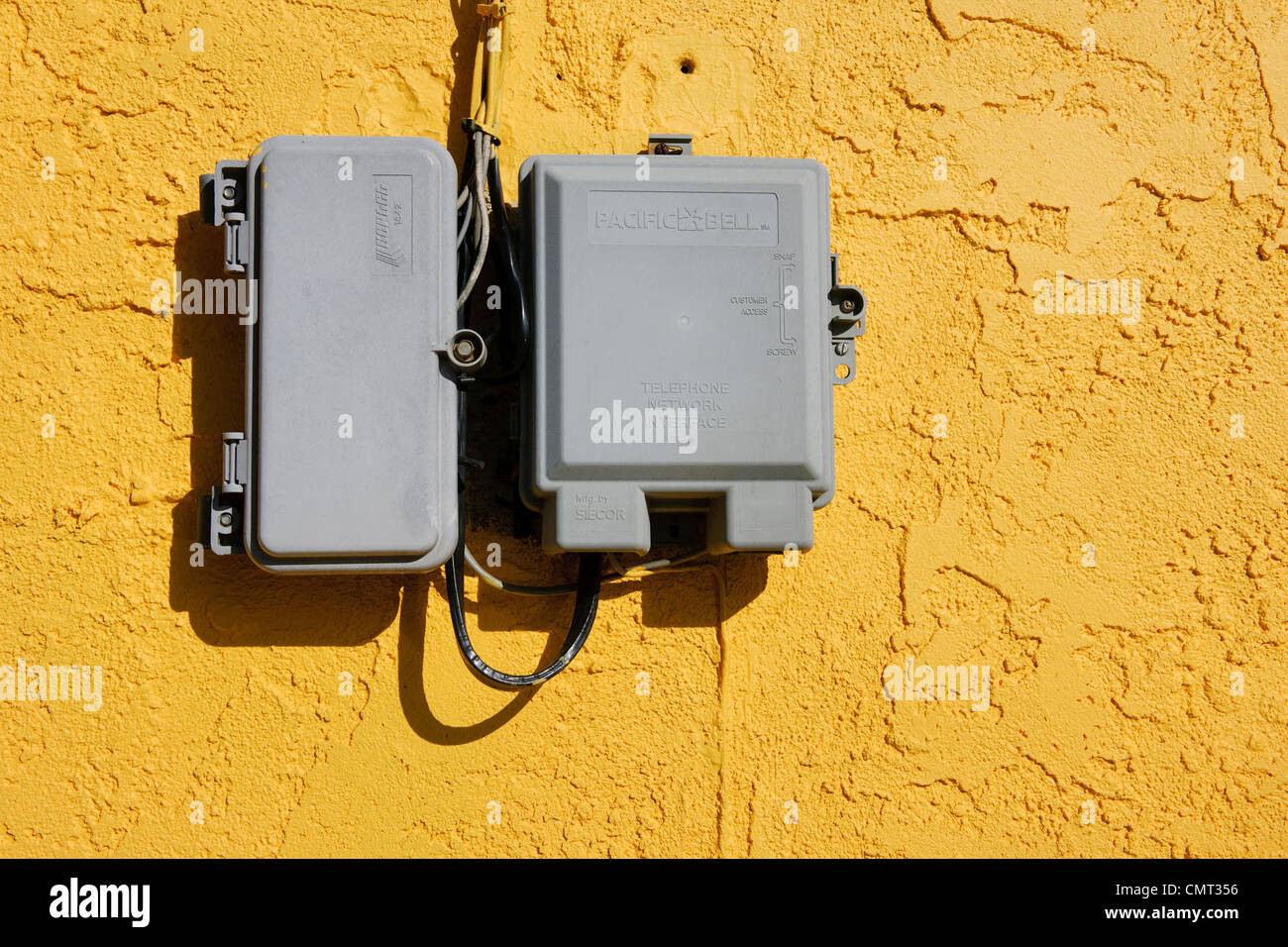 High tech electricity boxes on old textured yellow wall Stock Photo - Alamy