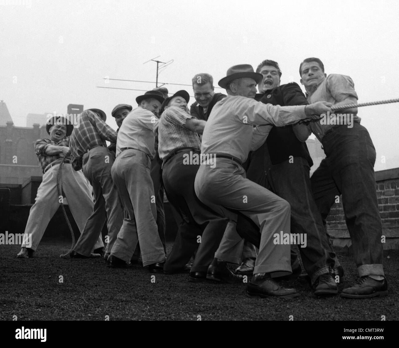 1950s MEN PLAYING TUG-OF-WAR Stock Photo