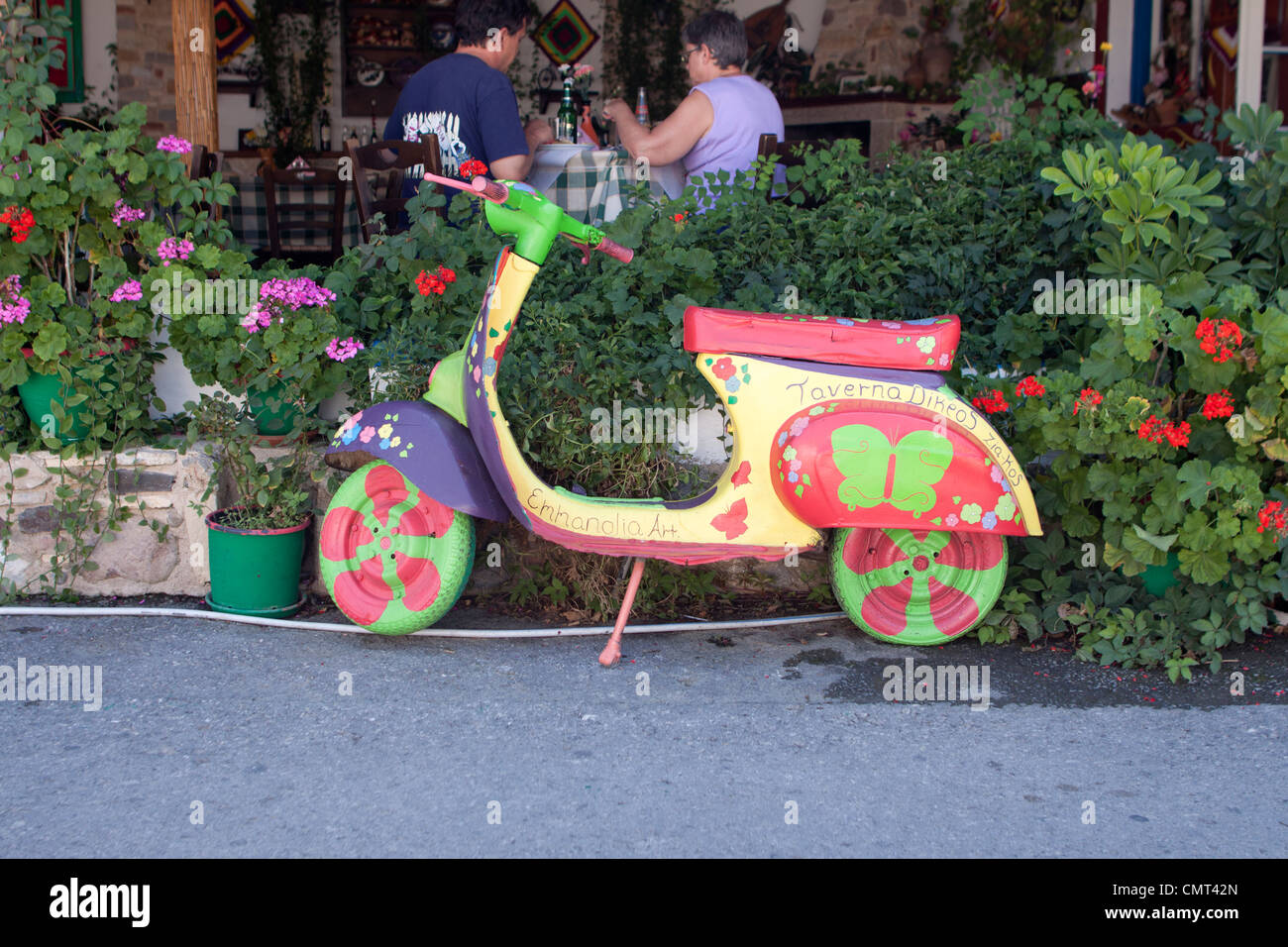 A painted moped motorcycle outside a restaurant on the Greek island of Kos, Greece Stock Photo