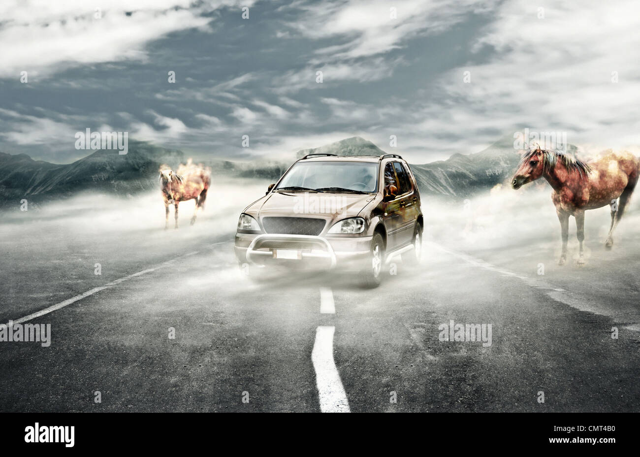 Surreal landscape with mist a car and two fire horses Stock Photo