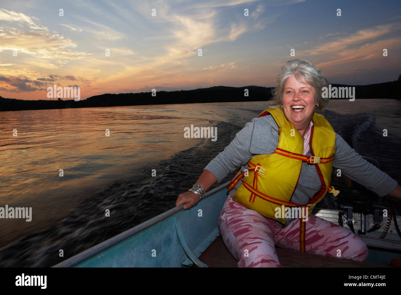 Woman Driving Motor Boat, Barry's Bay, Ontario Stock Photo