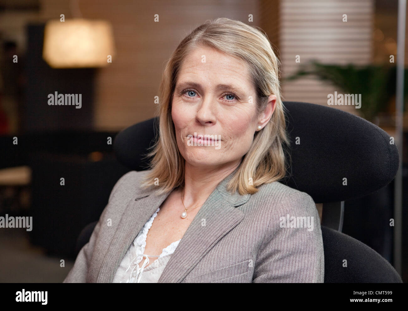 Portrait of business woman looking at camera Stock Photo - Alamy