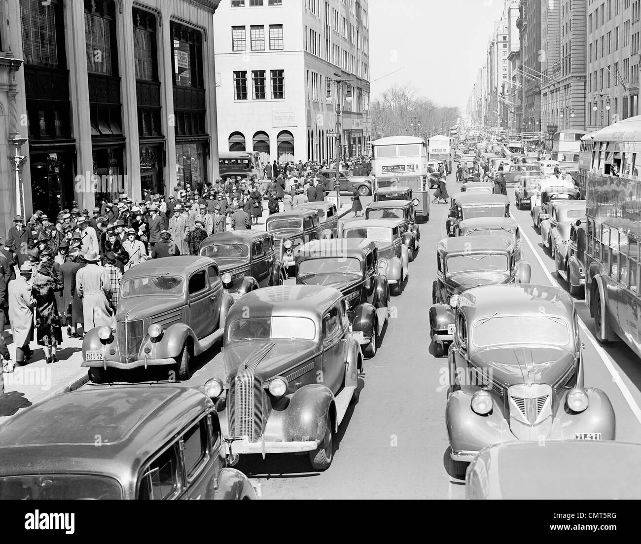 1930s PEDESTRIAN CROWDS AND TRAFFIC ON 5th AVENUE NYC CARS TAXIS BUSES ...