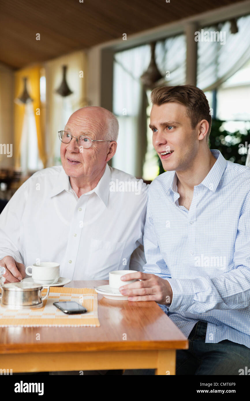Old man and young man drinking coffee Stock Photo Alamy