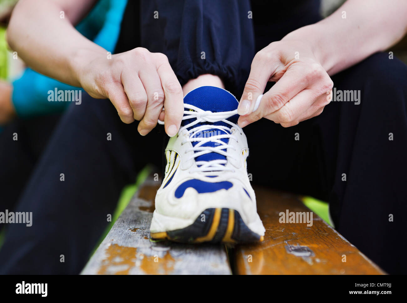 Close-up of woman's hand tying shoelace Stock Photo