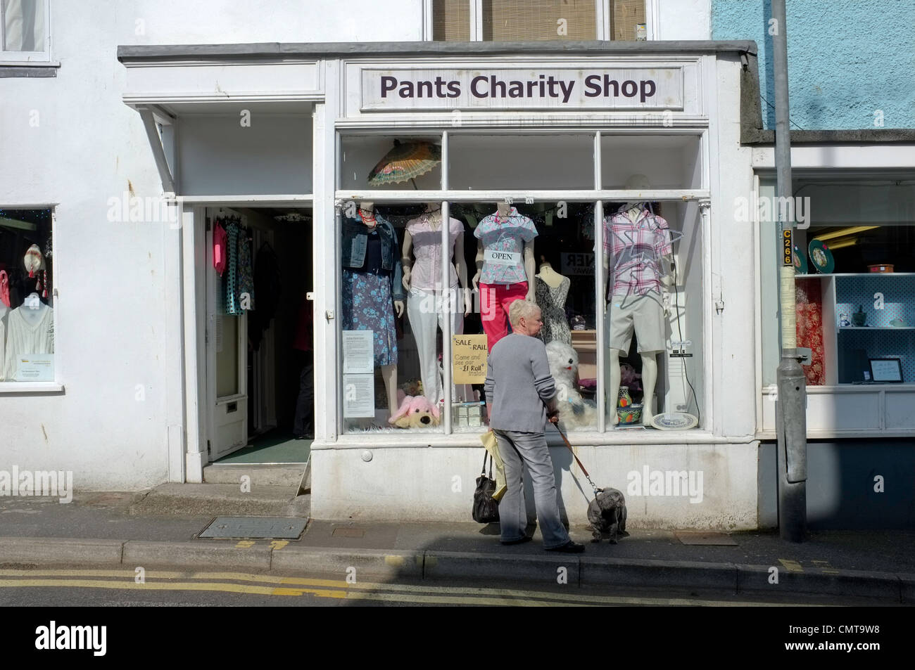 Lady outside a charity shop in Falmouth, UK. Pants is a charity raising