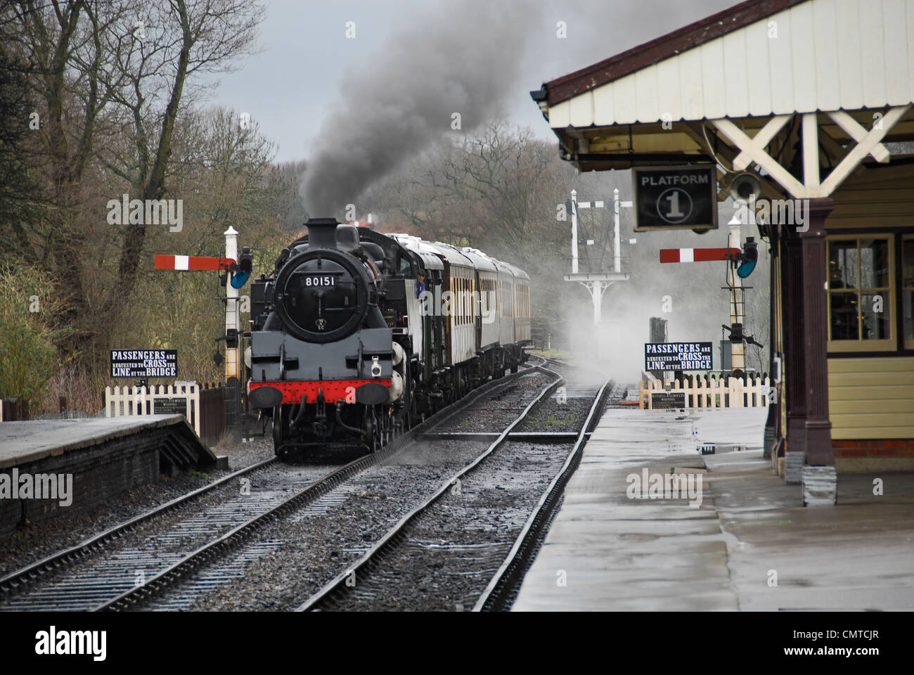 Steam locomotive pulling into railway station at Bluebell heritage steam railway in East Grinstead. Stock Photo
