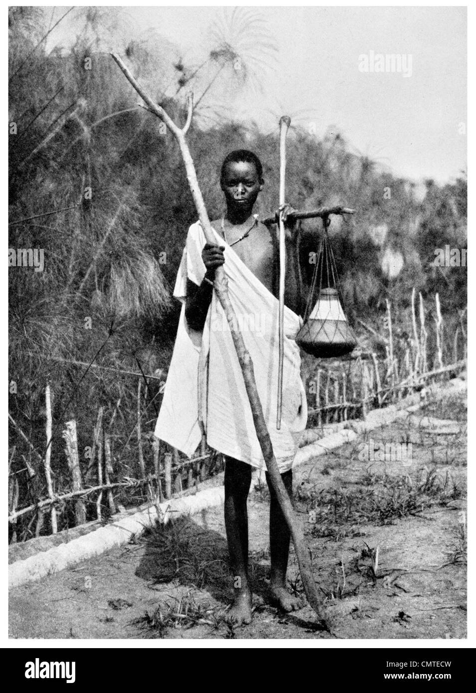 1925 Uganda Native Carrying Milk Stock Photo