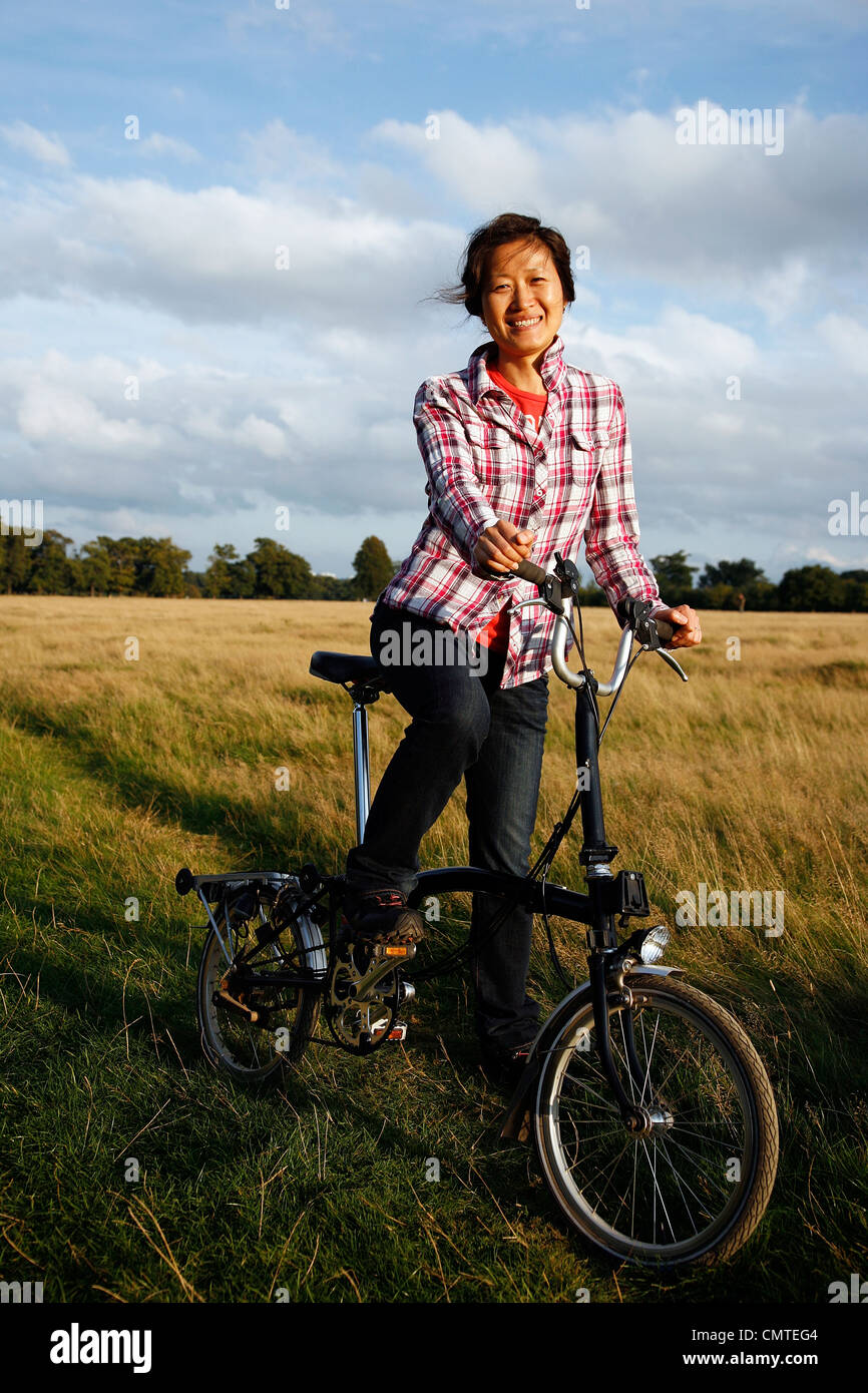 Premium Photo  Asian men's sunglasses try folding his folding bike to get  ready to go to work