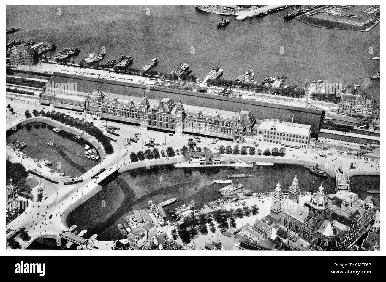 1925 Central station of Amsterdam with Harbour aerial view Holland Stock Photo
