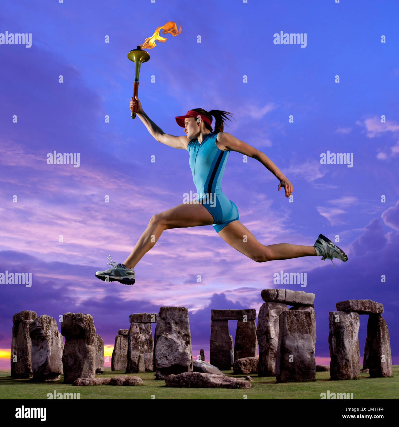 Athlete running with Olympic torch near Stonehenge Stock Photo Alamy