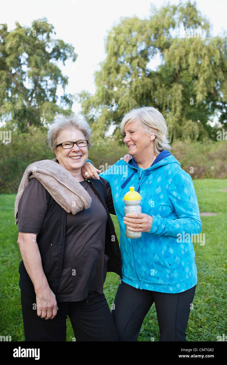 Smiling women standing in the park Stock Photo - Alamy